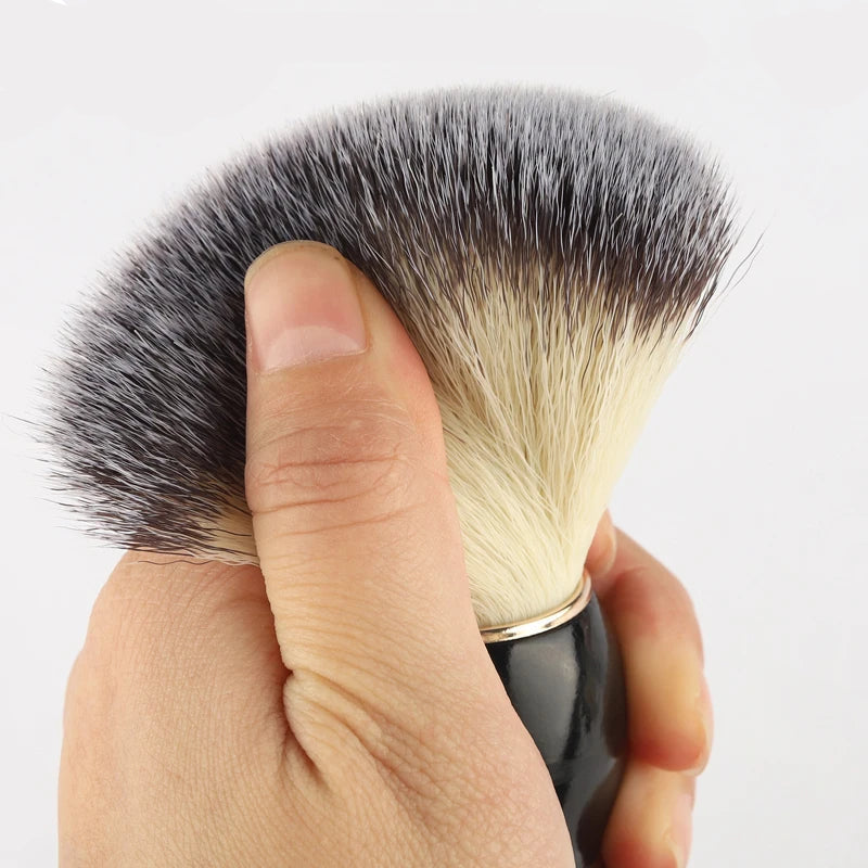 Makeup brush held by a hand with 'RANCAI' branding.