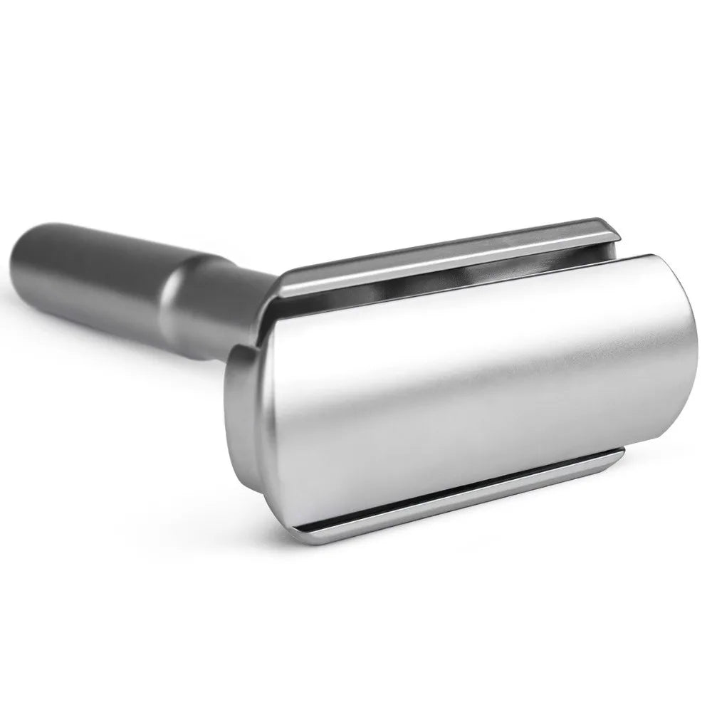 Metallic safety razor on a white background