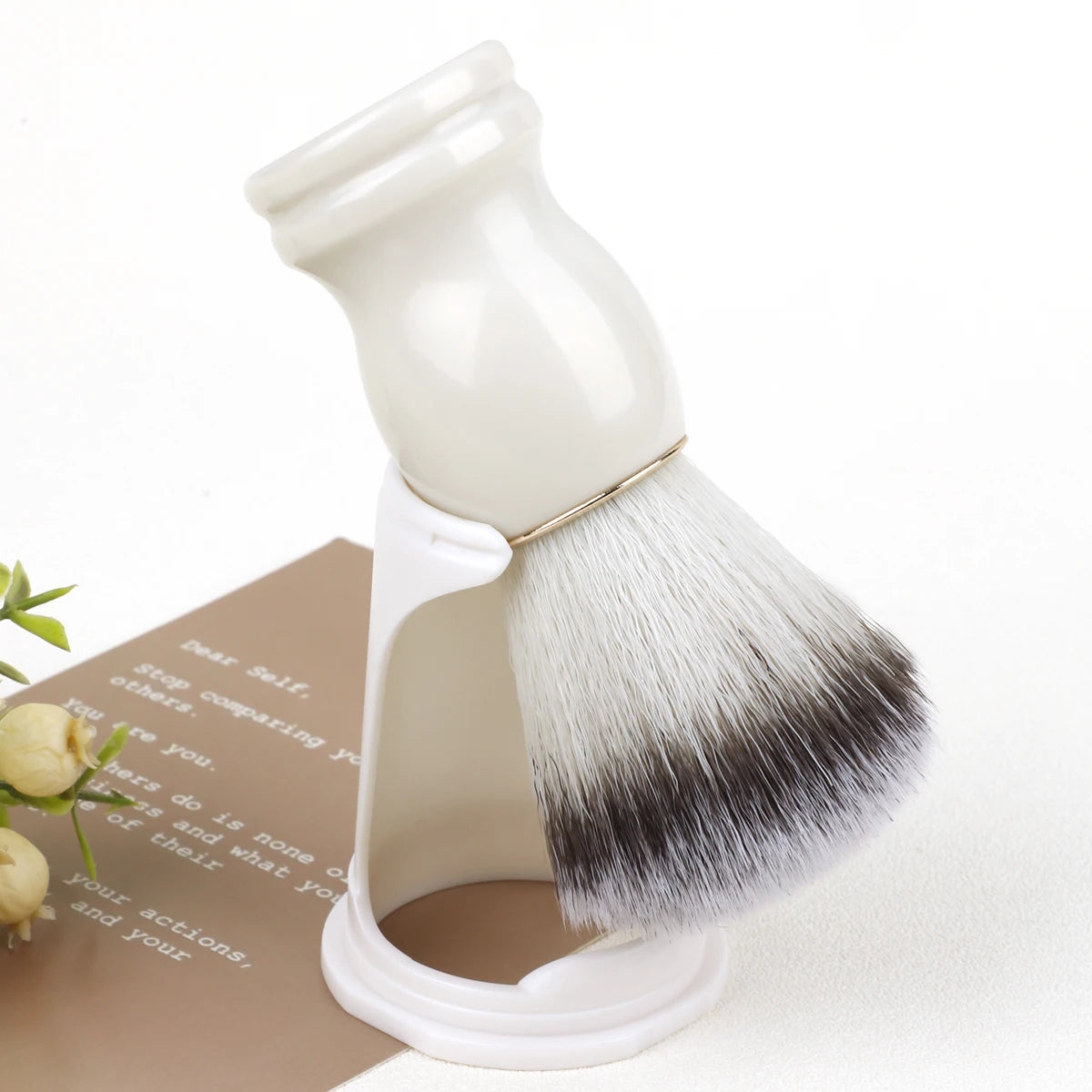 White shaving brush with black bristles on a white background