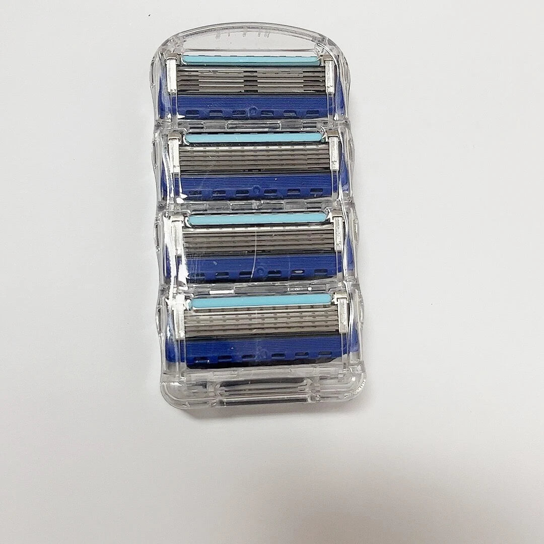 Set of razor blades in a clear plastic case on a white background