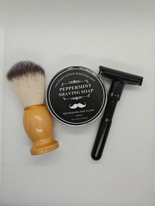 Shaving brush, peppermint shaving soap, and safety razor on a white background