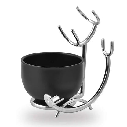 Black bowl with a decorative metal stand on a white background