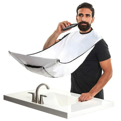 Man using a hair dryer with a white bib over his clothes in a bathroom setting.