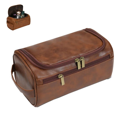 Brown leather toiletry bag with gold zippers on a white background